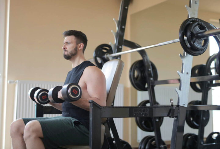Um homem levantando pesos em uma academia