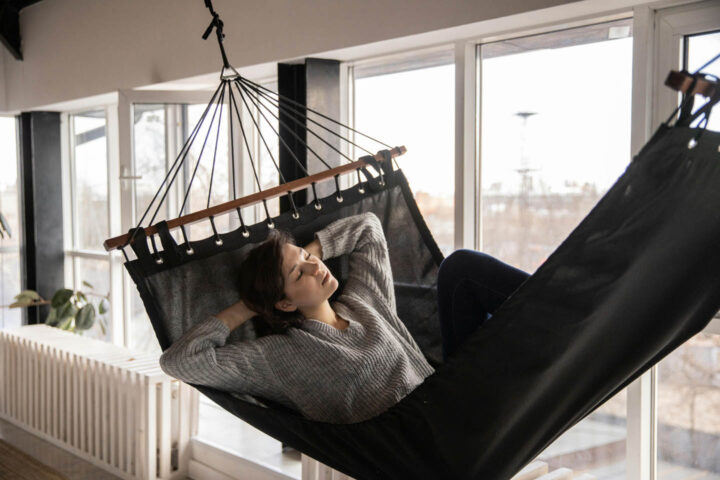A woman resting in a hammock at home