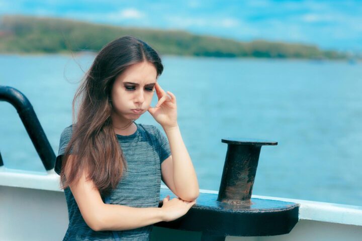 A woman being sea sick on a ship